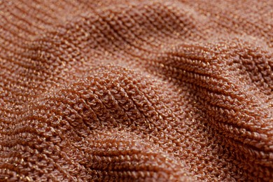 Brown knitted fabric as background, closeup view