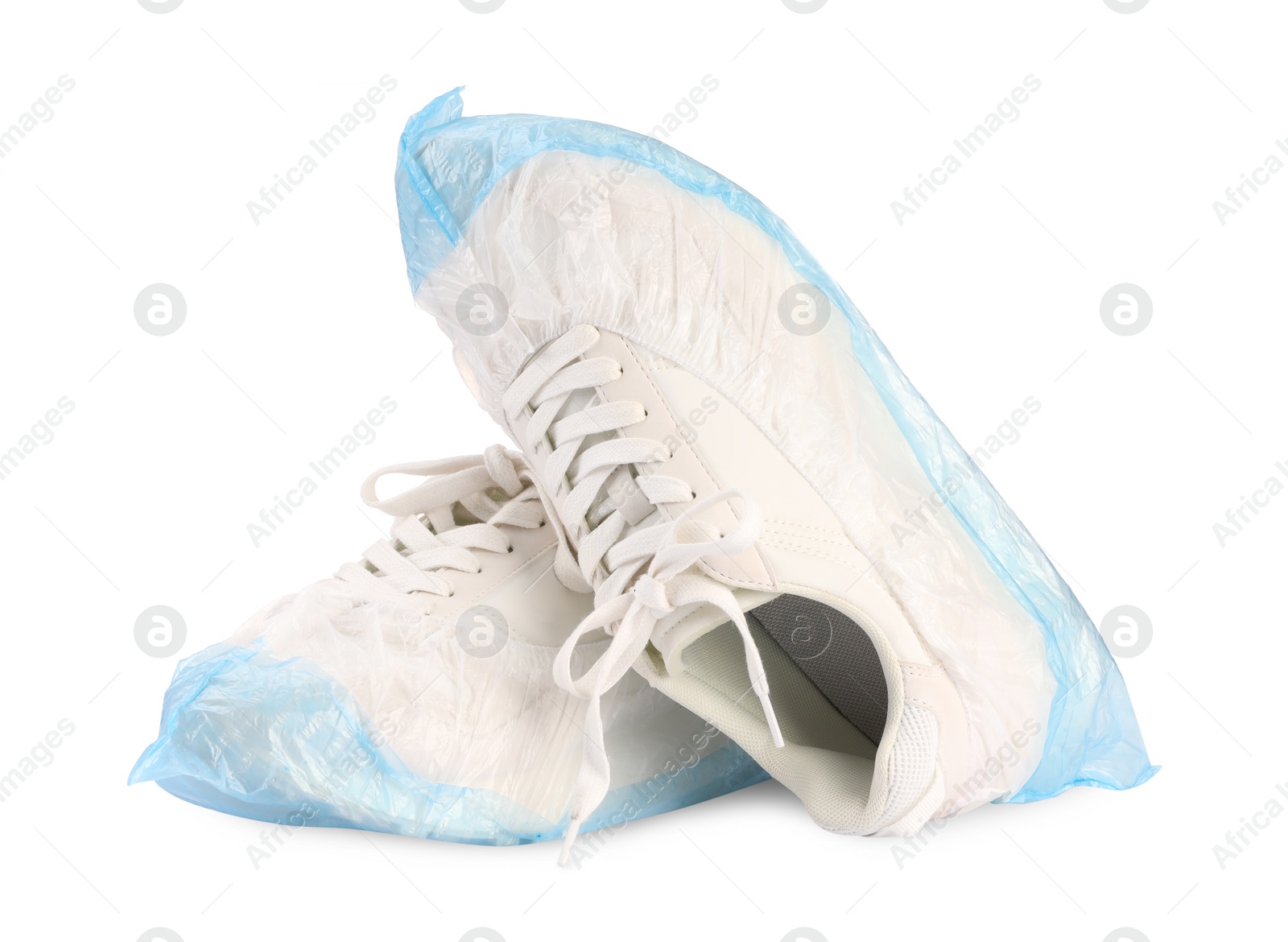 Photo of Sneakers in shoe covers isolated on white