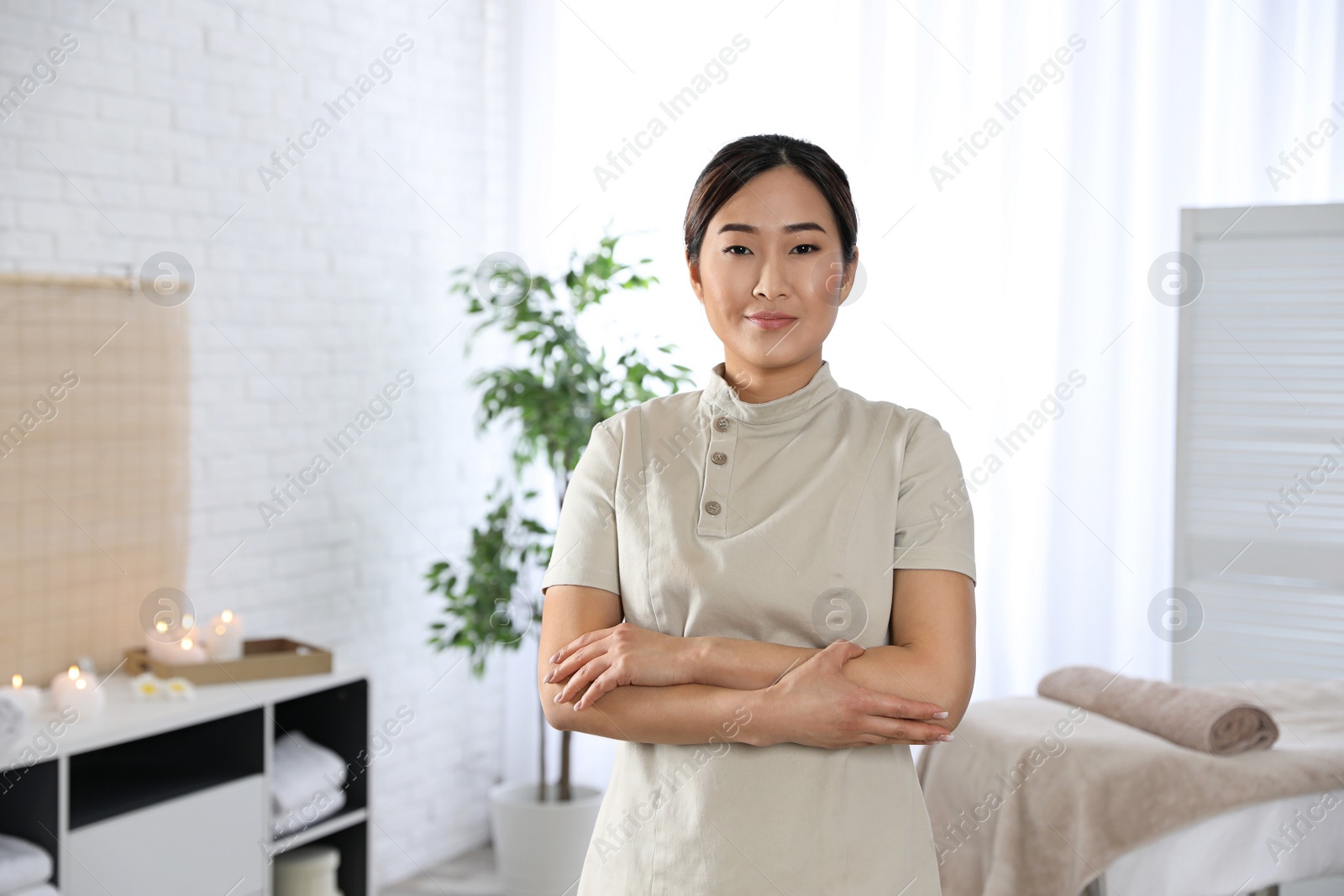 Photo of Portrait of young Asian masseuse in spa salon