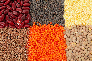 Photo of Different grains and cereals as background, top view