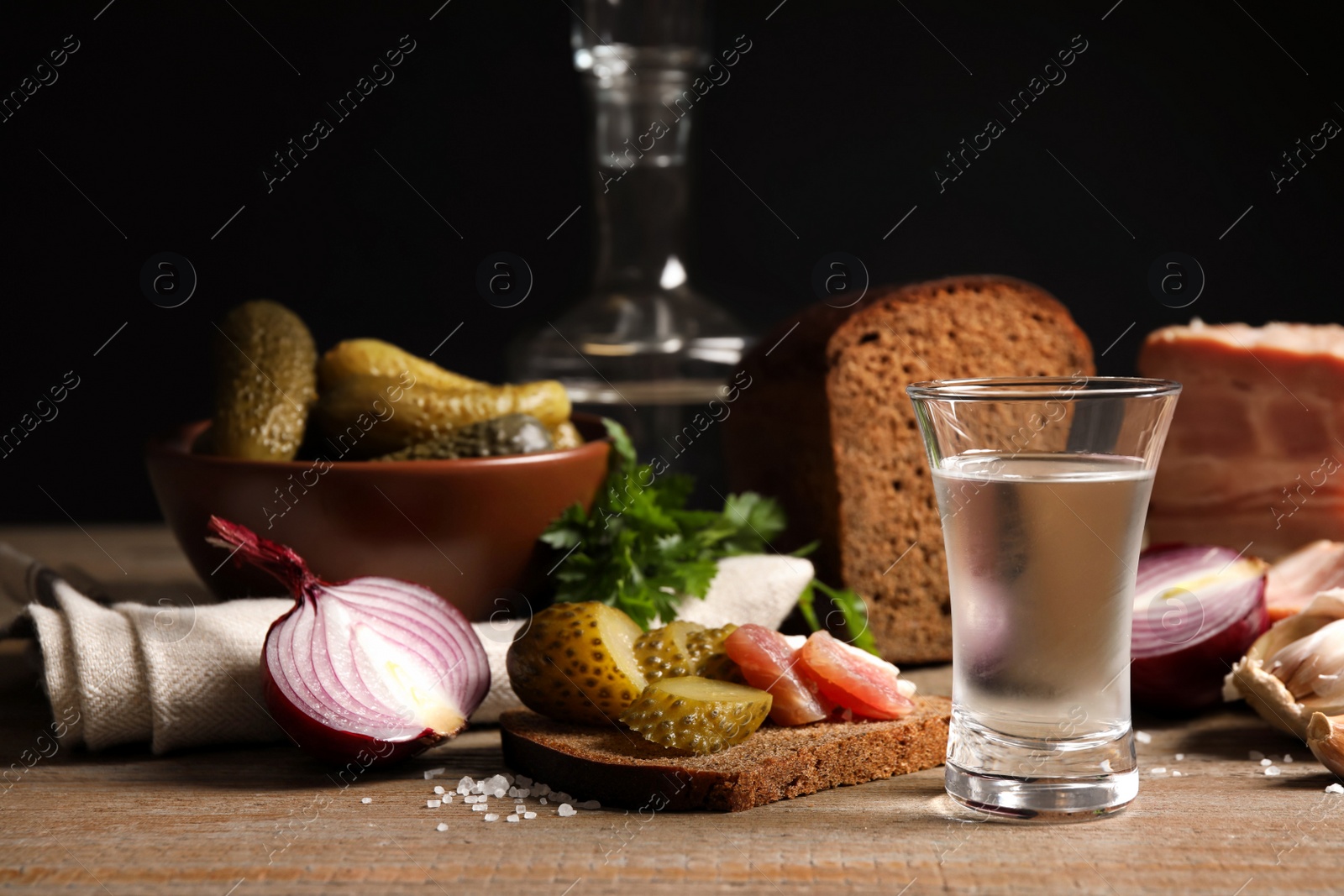 Photo of Cold Russian vodka with snacks on wooden table