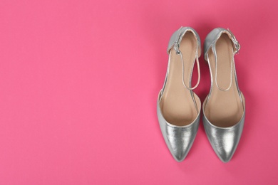 Photo of Pair of female shoes on color background, top view