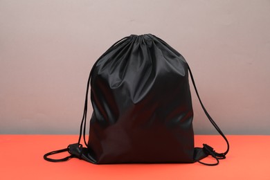 Photo of One black drawstring bag on grey background