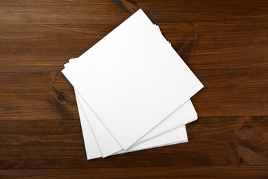 Stack of blank paper sheets on wooden table. Brochure design