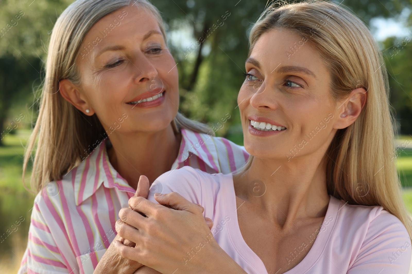 Photo of Family portrait of mother and daughter outdoors