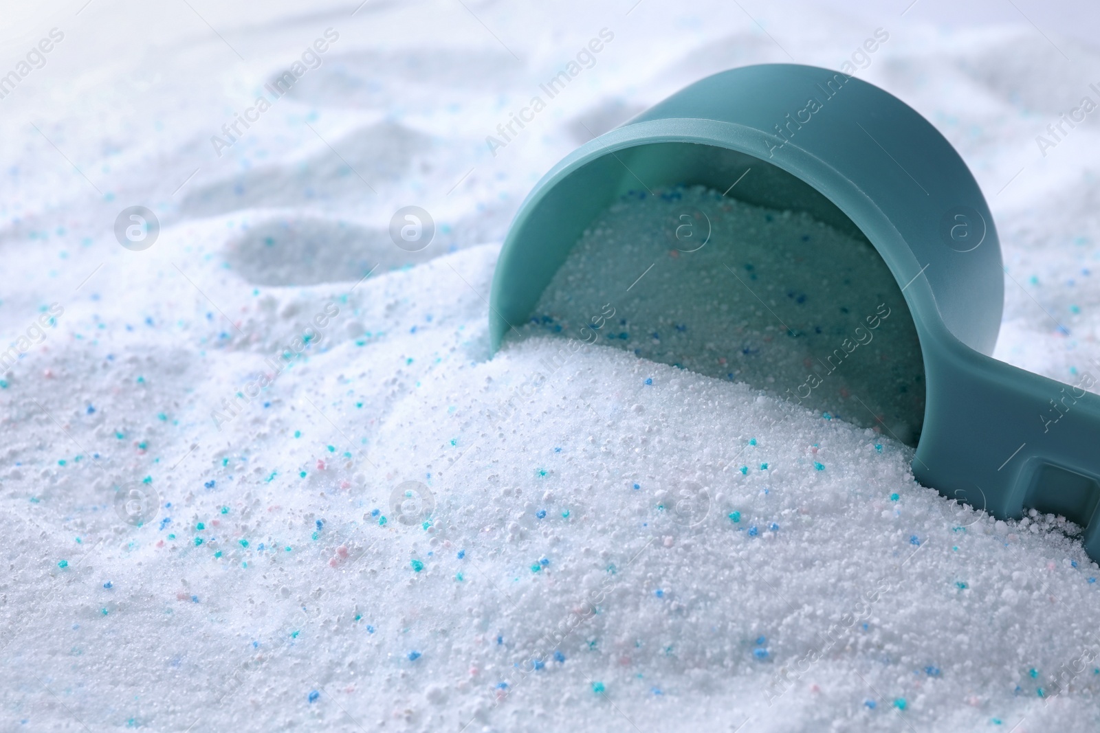 Photo of Measuring spoon with laundry powder, closeup view