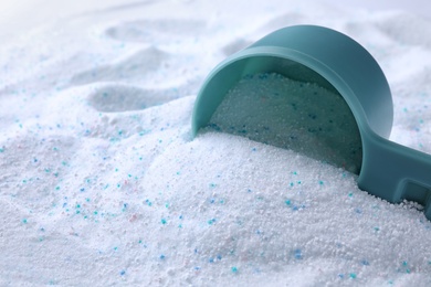 Photo of Measuring spoon with laundry powder, closeup view