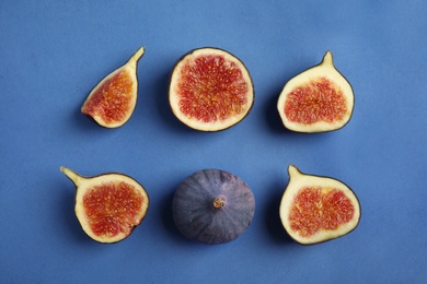 Delicious ripe figs on blue background, flat lay