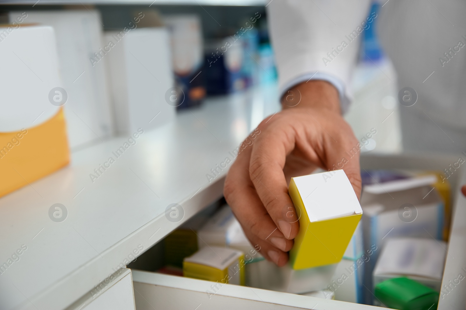 Photo of Professional pharmacist with medicine in drugstore, closeup