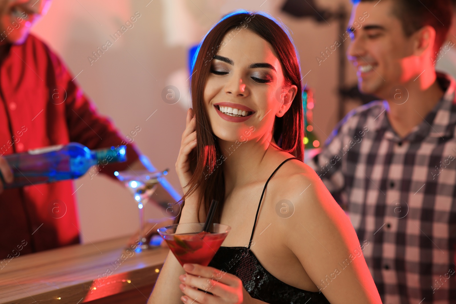 Photo of Beautiful young woman with glass of martini cocktail in bar