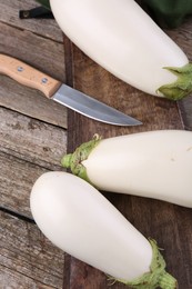 Fresh white eggplants on wooden table, above view