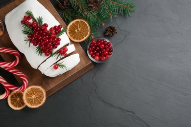 Photo of Traditional Christmas cake and ingredients on black table, flat lay with space for text. Classic recipe