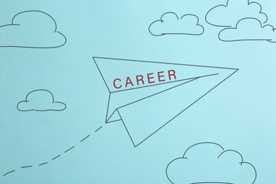 Photo of Drawing of paper plane with word CAREER in blue sky, top view. Promotion concept