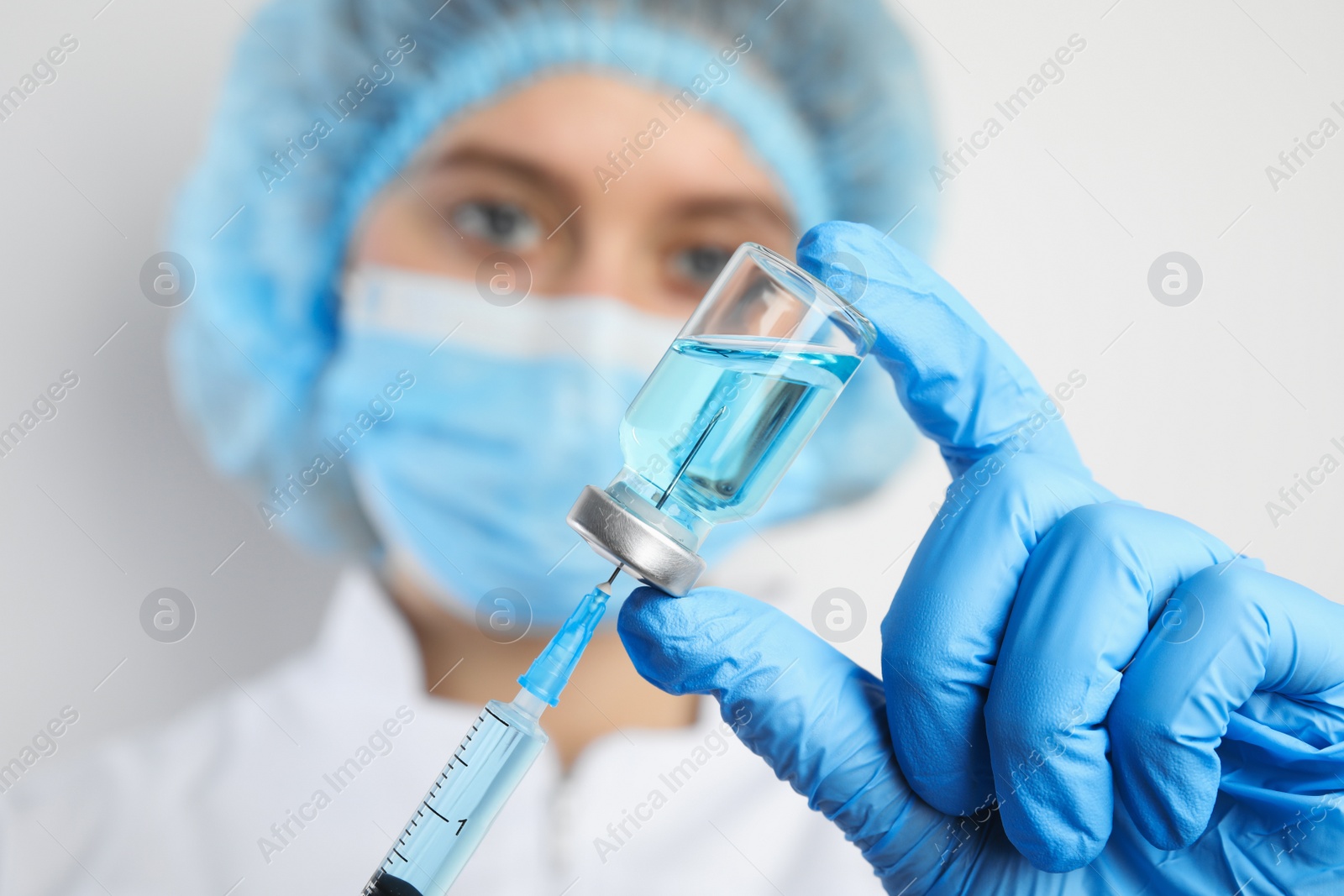 Photo of Doctor filling syringe with medication, closeup. Vaccination and immunization