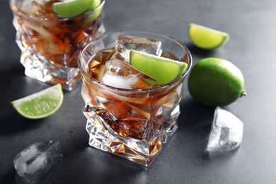 Photo of Glass of refreshing drink with ice cubes and lime on table