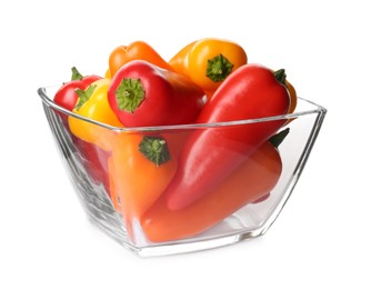 Photo of Glass bowl of ripe bell peppers isolated on white