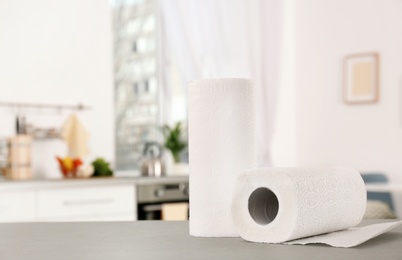 Photo of Rolls of paper towels on table in kitchen