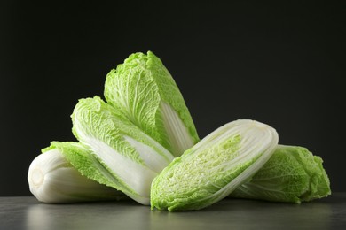 Photo of Fresh ripe Chinese cabbages on grey table