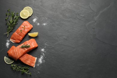 Photo of Fresh salmon and ingredients for marinade on black table, flat lay. Space for text