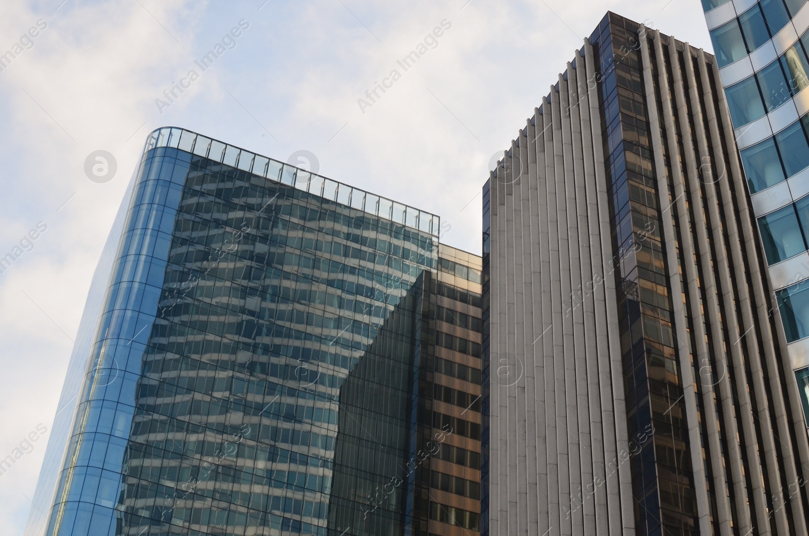 Photo of Exterior of different modern skyscrapers against blue sky, low angle view