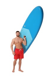 Handsome man with blue SUP board on white background