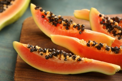 Photo of Fresh sliced papaya fruit on table, closeup
