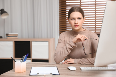Photo of Professional psychotherapist at table in modern office