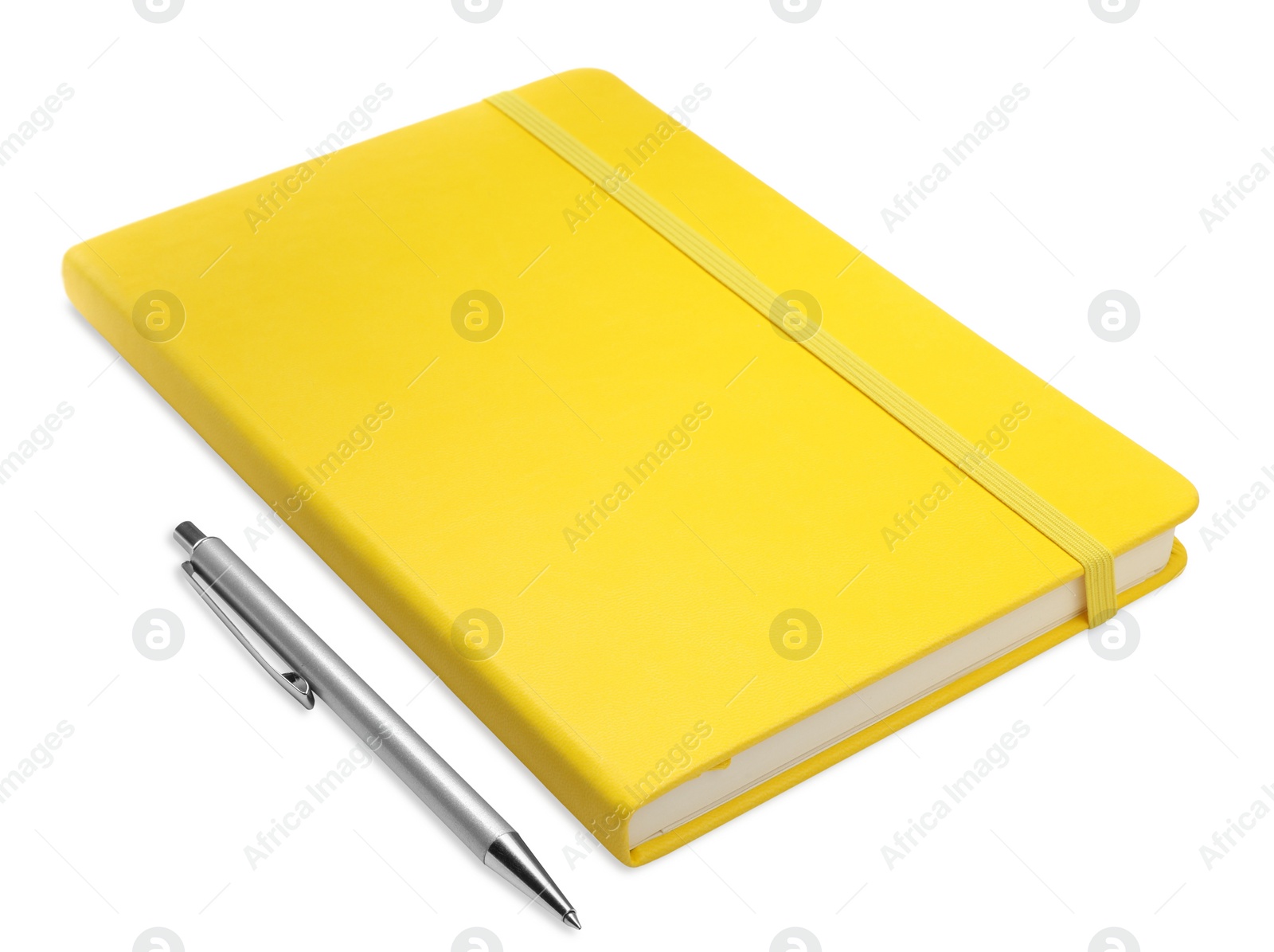 Photo of Closed yellow notebook with pen isolated on white