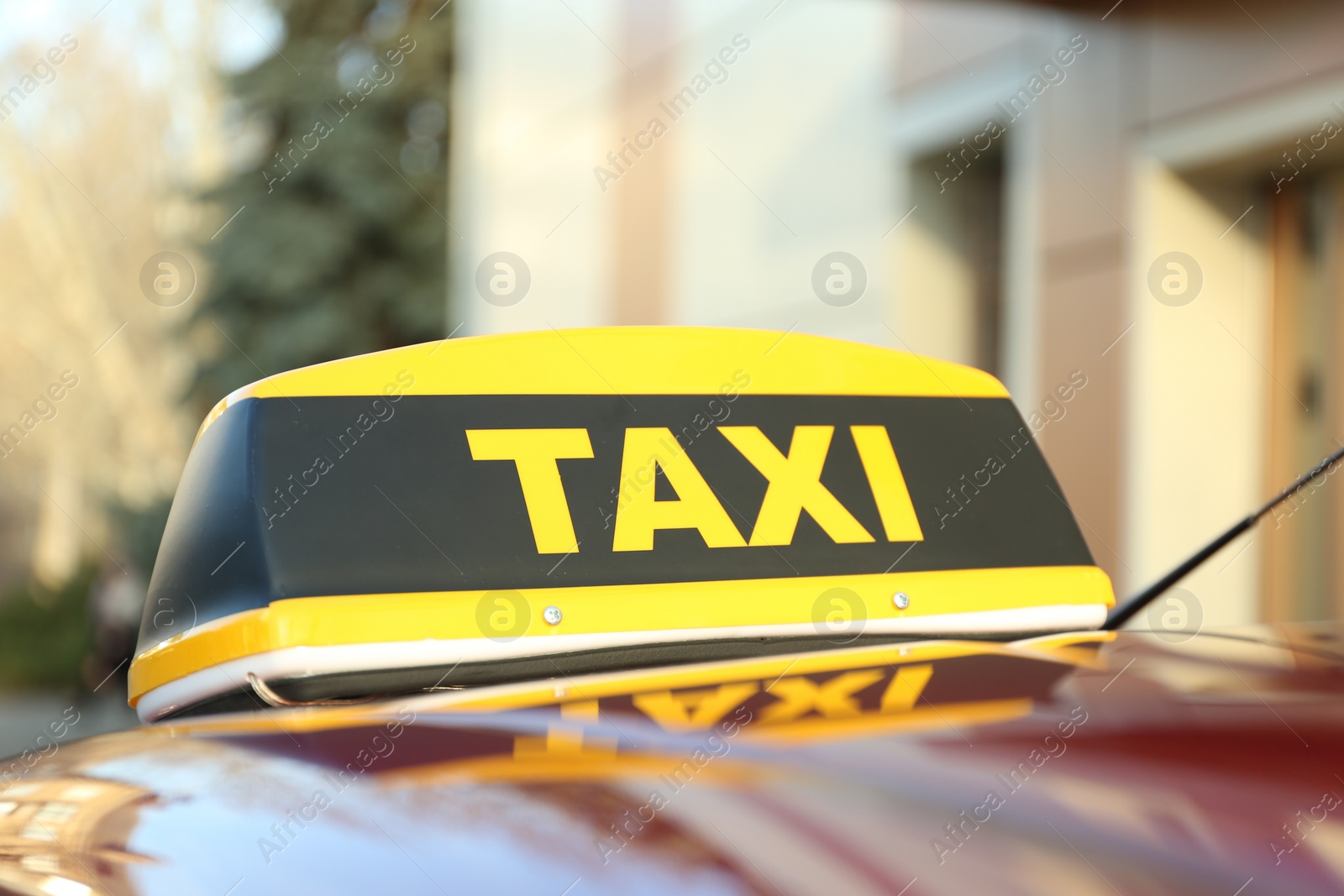 Photo of Roof light with word TAXI on car outdoors