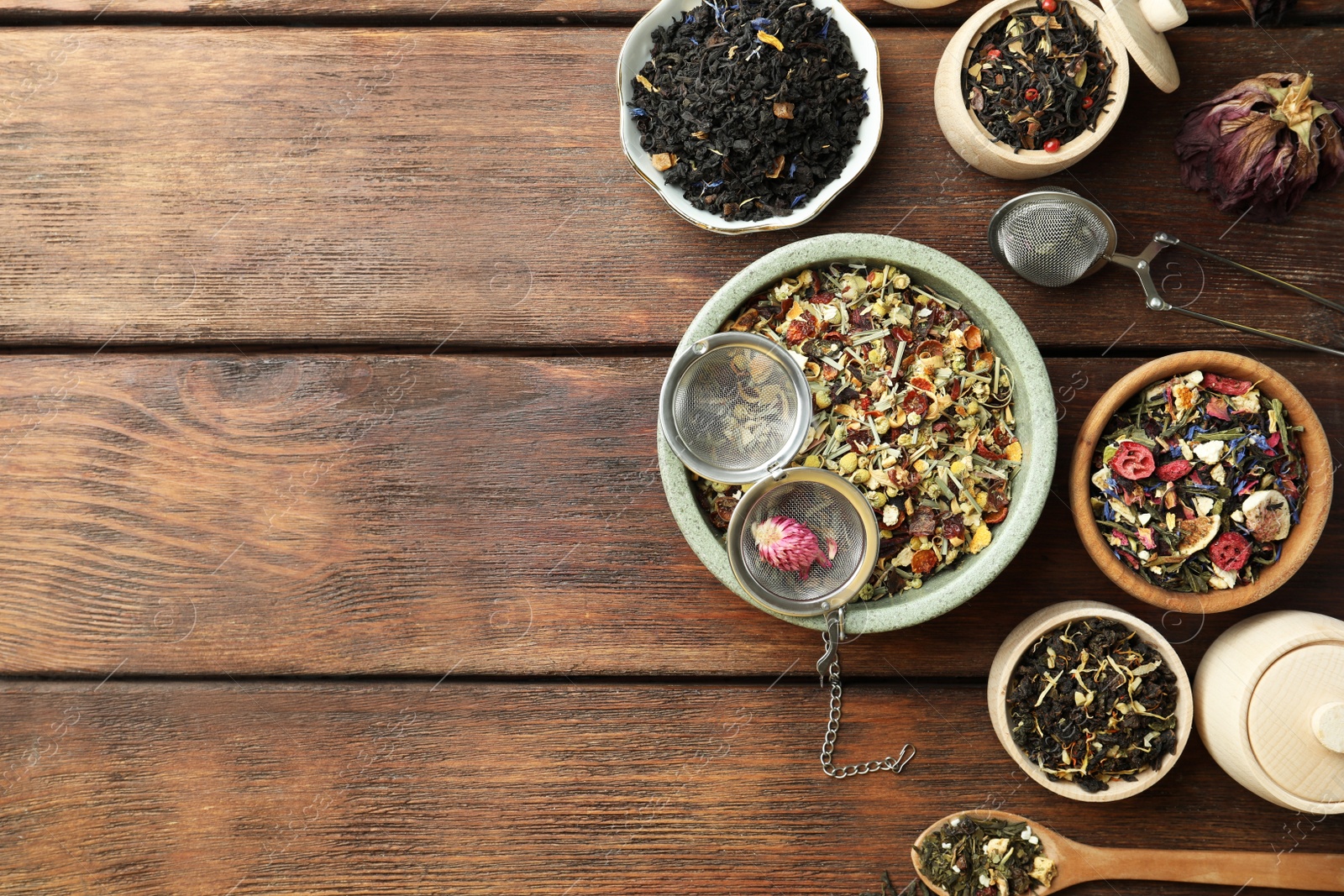 Photo of Many different herbal teas on wooden table, flat lay. Space for text