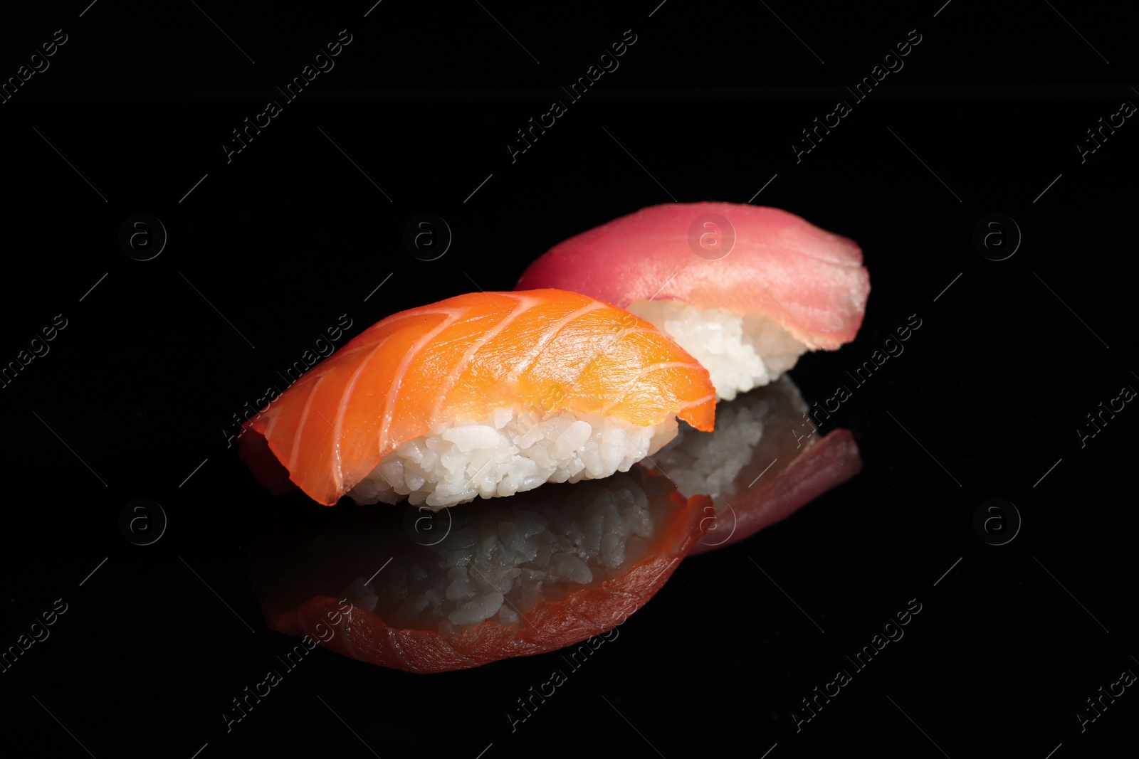 Photo of Delicious nigiri sushi on black background. Traditional Japanese cuisine