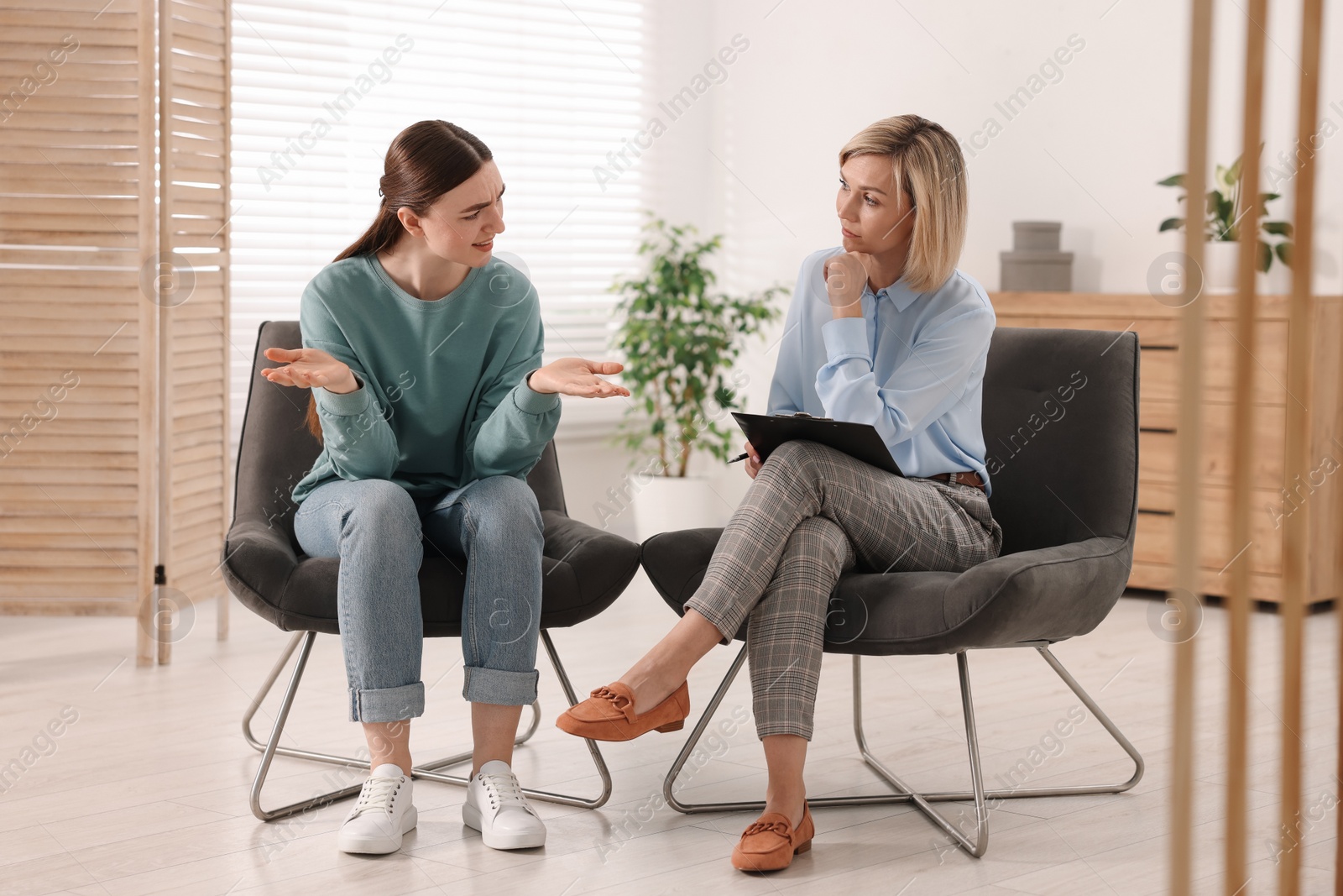 Photo of Professional psychotherapist working with patient in office