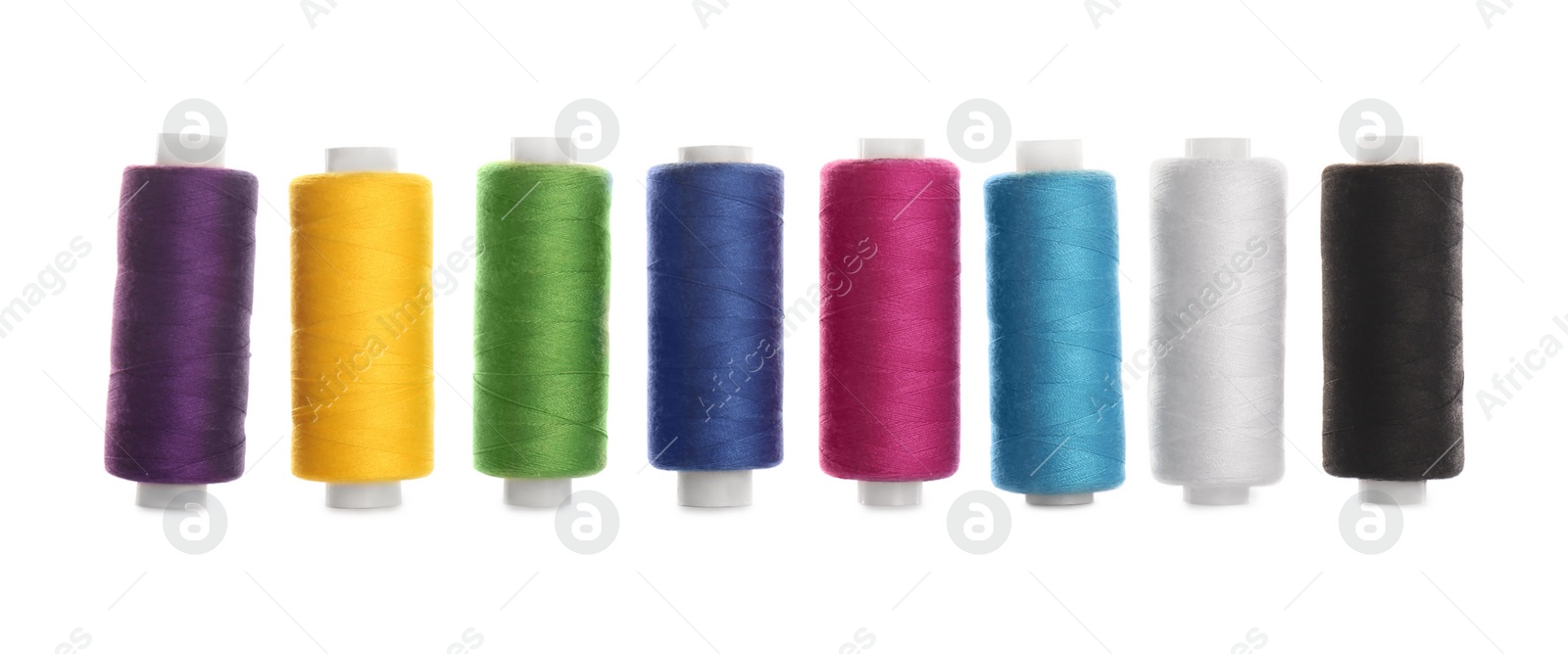 Photo of Set of colorful sewing threads on white background