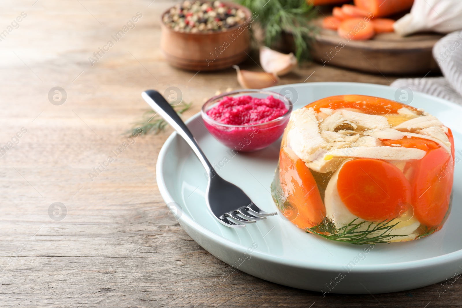 Photo of Delicious chicken aspic served on wooden table