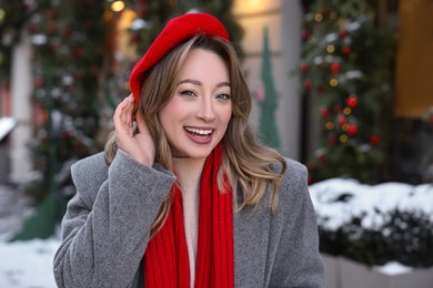Photo of Portrait of happy woman on city street in winter