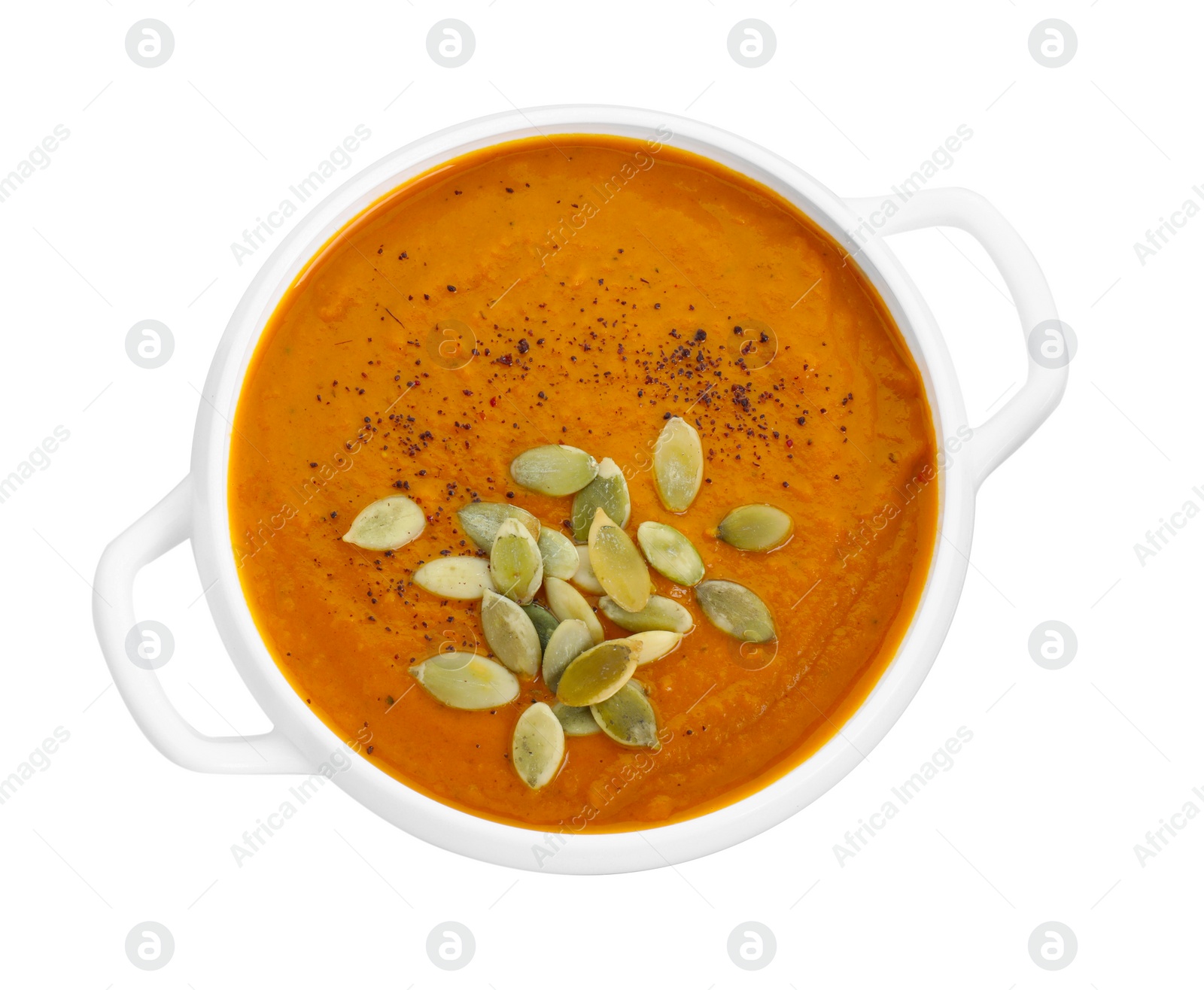 Photo of Delicious pumpkin cream soup with seeds in bowl isolated on white, top view