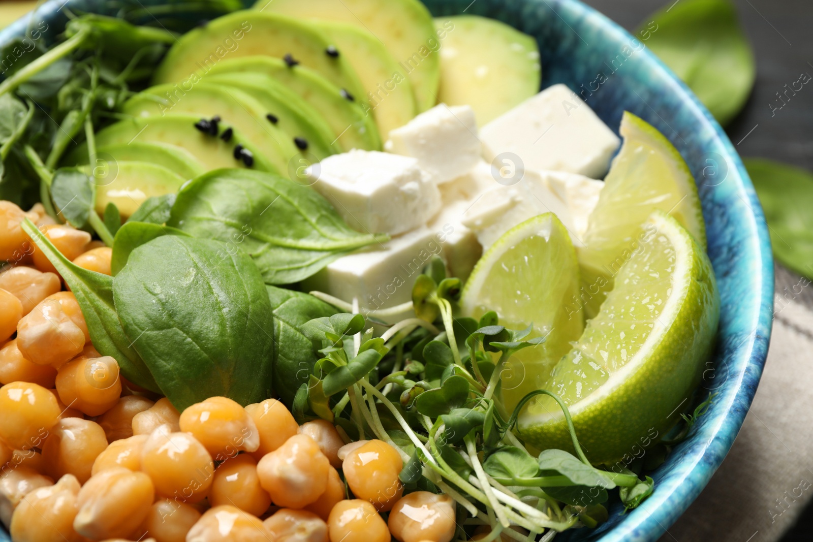 Photo of Delicious avocado salad with chickpea in bowl, closeup