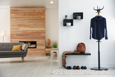 Hallway interior with stylish furniture, clothes and accessories