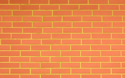 Texture of bright orange brick wall as background