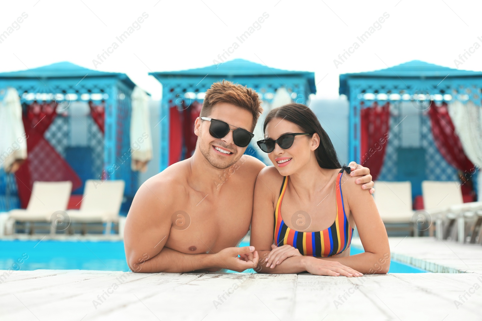 Photo of Woman in bikini with boyfriend at resort. Happy young couple