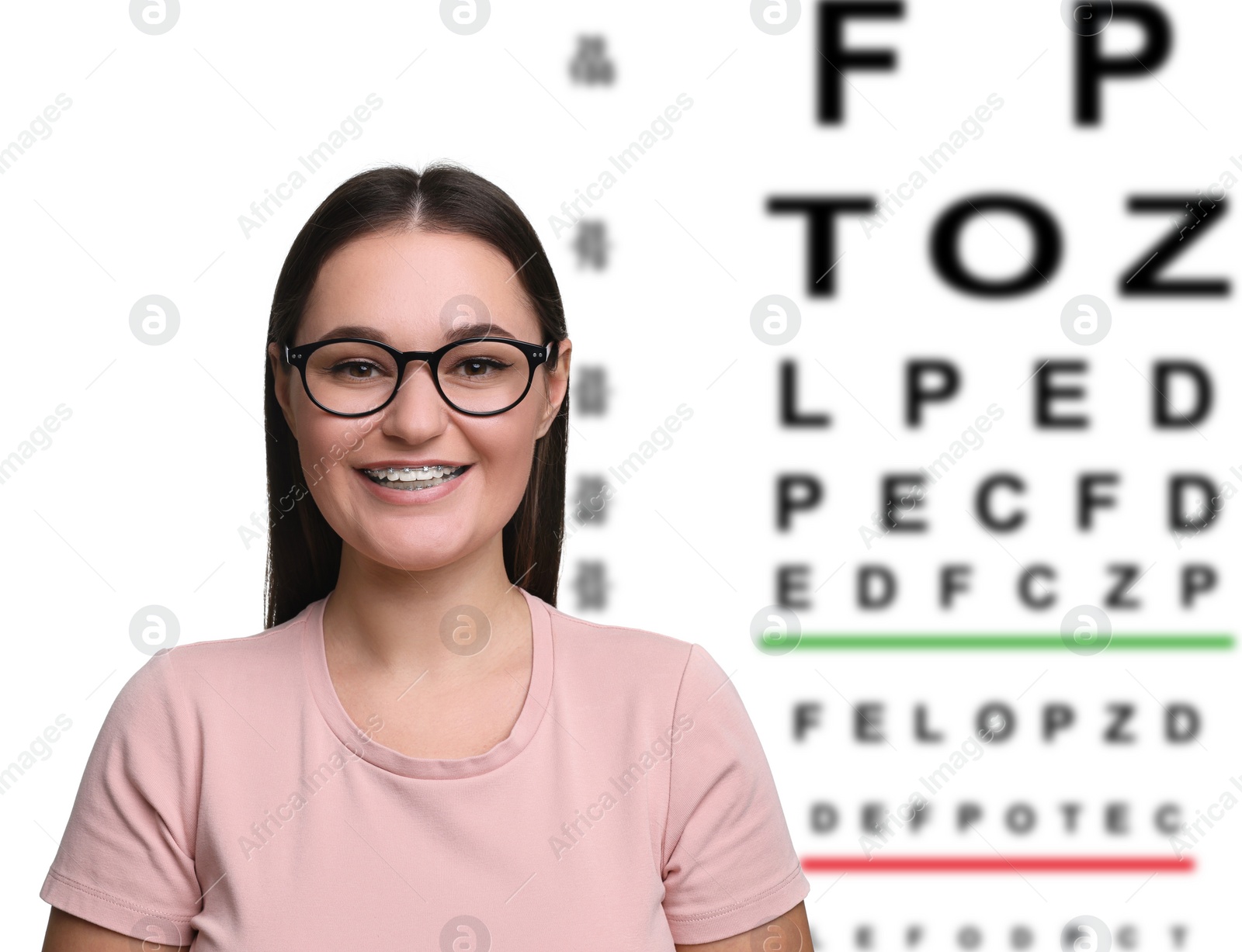 Image of Vision test. Young woman with glasses and eye chart on white background
