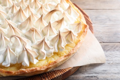 Photo of Delicious lemon meringue pie on wooden table, closeup