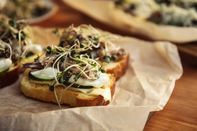 Photo of Delicious bruschettas served on wooden table, closeup