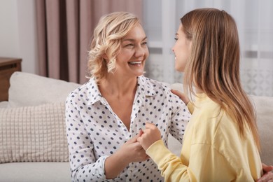 Photo of Young woman with her mom at home. Happy Mother's Day