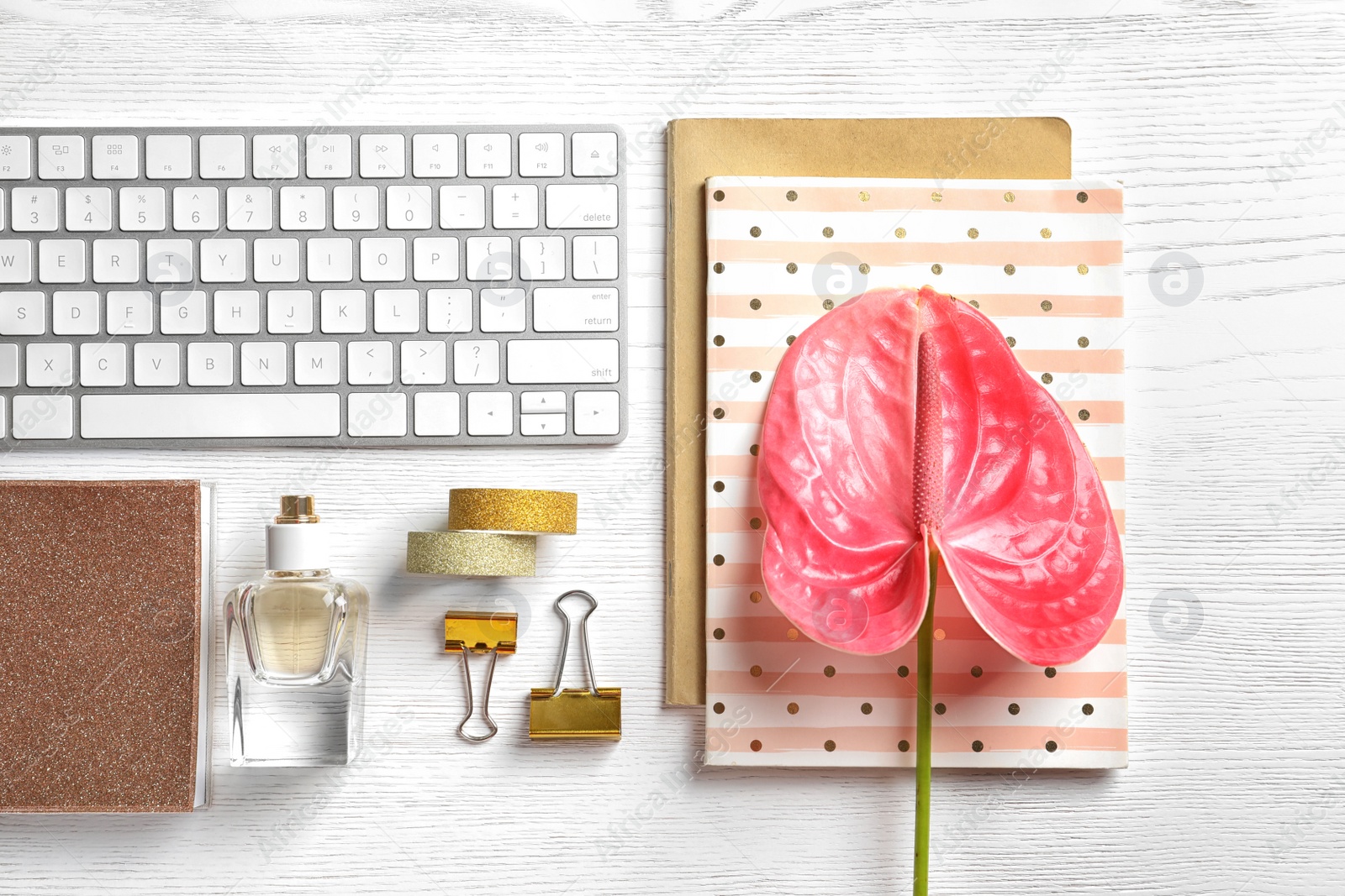 Photo of Creative flat lay composition with tropical flower and computer keyboard on wooden background