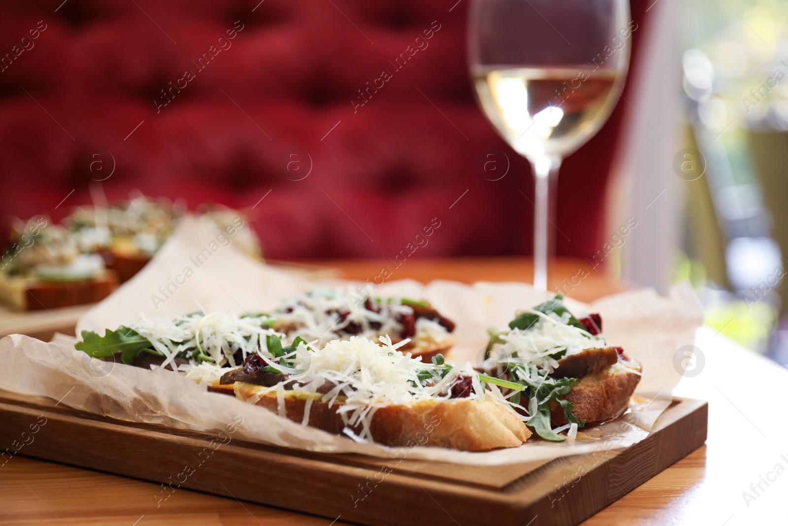Photo of Delicious bruschettas with beef and cheese on table