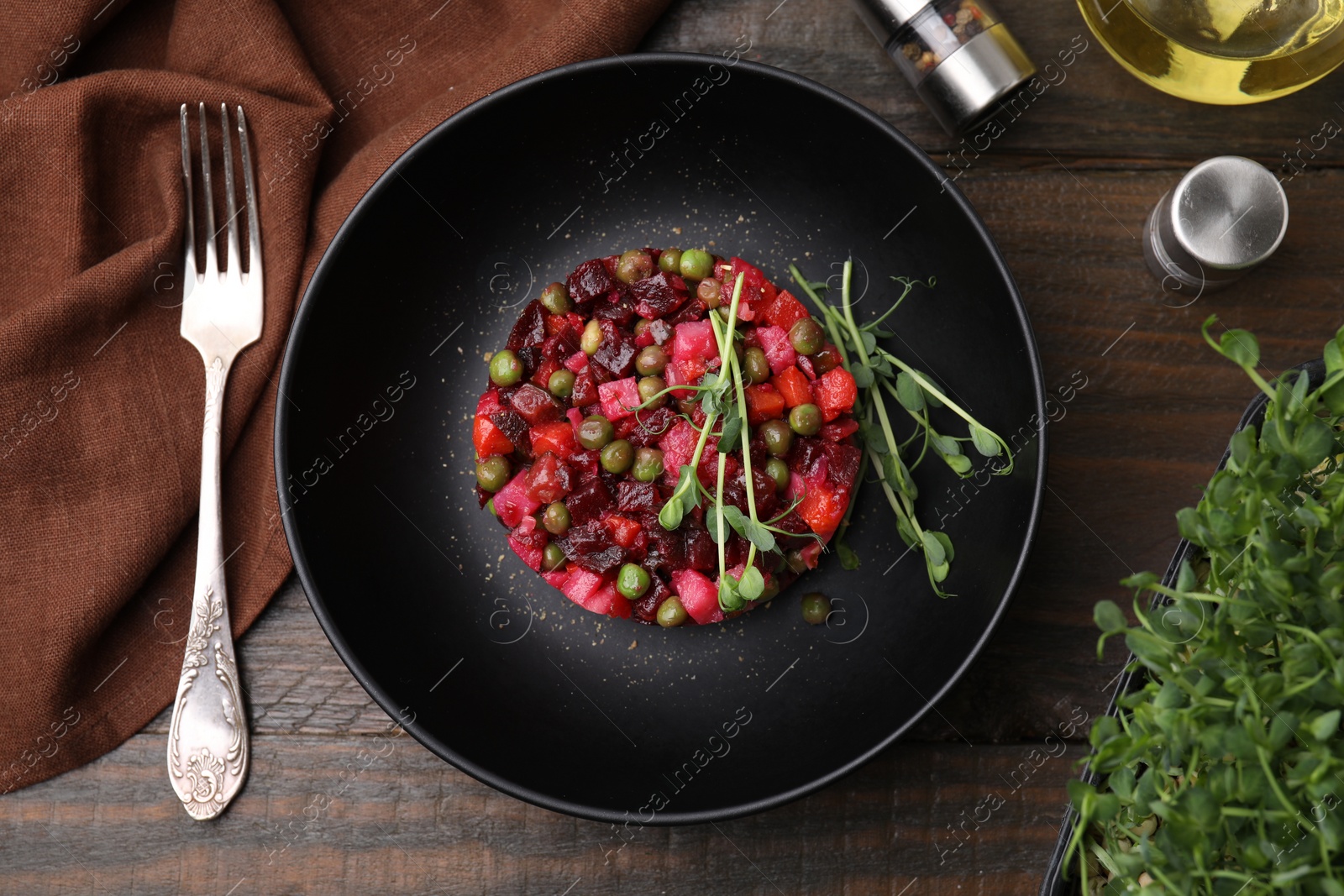 Photo of Delicious vinaigrette salad on wooden table, flat lay