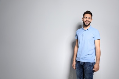 Photo of Portrait of handsome young man against light background. Space for text