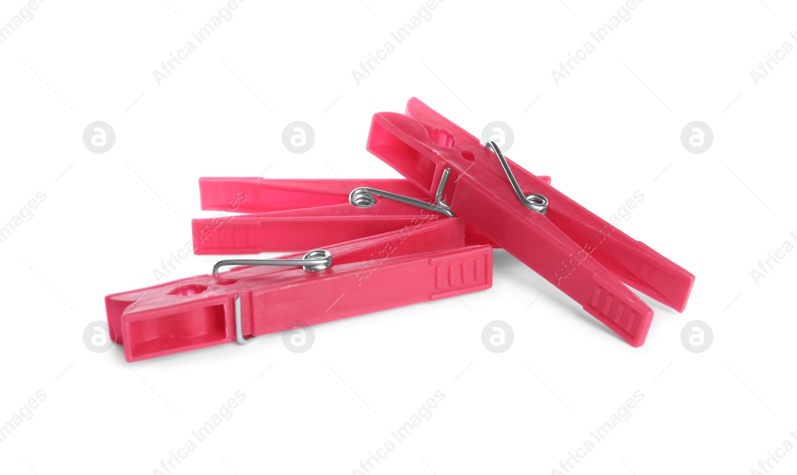 Photo of Bright pink plastic clothespins on white background