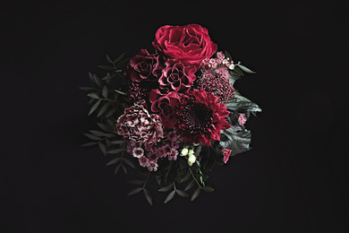 Photo of Beautiful fresh flowers on black background. Floral card design with dark vintage effect